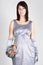 Woman in silver evening dress holding gift