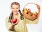 Woman sincere villager carry basket with natural fruits. Woman gardener rustic style offer you apple on white background