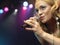 Woman singing in concert on stage in front of adoring fans low angle view