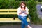 Woman in singular mask read book in the park