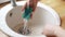 The woman of sinks a sink in kitchen. Cleaning.