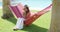 Woman sipping coconut drink in hammock