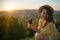 Woman sit on the hill and lookin on sunset