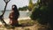 Woman sit under tropical coconut palm back view