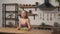 Woman siting at a table on the home kitchen. Sporty girl eating cabbage leaves adheres to a diet