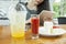 Woman siting on wood table with smart pad in hand and strawbery crape cake ready to eat on table