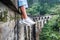 Woman sits on the Demodara nine arches bridge in Ella, Sri Lanka