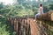 Woman sits on the Demodara nine arches bridge the most visited s