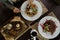 Woman sits at a dinner table with a vegetable salad with poached egg and grilled steak