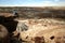 A Woman Sits on a Ledge in Petrified Forest