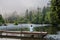 Woman Sits on Simple Wooden Footbridge