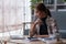 Woman sits on sofa at home, studying and analyze house bills and submitting tax forms.