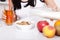 Woman sits at a table and eat breakfast. Women eating healthy food for breakfast. Fruit, cereal and milk, close up selective focus