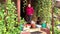 Woman sits with two baskets on the porch