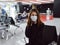 woman sitting at the airport wearing a medical mask long waiting for a flight