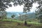 A woman sitting alone and looking at greenery mountains with blue sky and beautiful nature