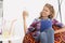 Woman sitting on an armchair with the glass of lemonade