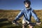 Woman Sitting On Bicycle In Field