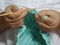 Woman sitting on a braided hair with a hat hobby