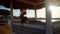 Woman sitting at Cabana with straw roof on a sandy beach on sunset