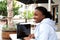 Woman sitting at cafe garden surfing internet