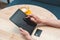 Woman sitting in cafe and using digital tablet and credit card