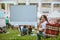 woman sitting in camping chair watching movie at open air cinema