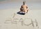 Woman sitting coconut tropical beach sand writing
