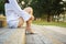 Woman sitting on concrete stairs in the park.