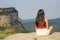 Woman sitting contemplating views in the mountain