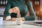 Woman sitting at desk managing expenses, calculating expenses, paying bills using laptop online, making household financial