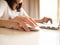 Woman sitting at desk and working at computer hands close up. Homeoffice