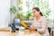 a woman is sitting at a desk working on a yellow book