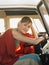 Woman Sitting At Driver\'s Seat Of Campervan