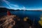 Woman Sitting on the Edge of a Cliff looking at Crater Lake Oreg