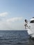 Woman Sitting At Edge Of Yacht