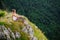 Woman sitting at the end of earth in fascinating landscape