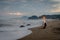 A woman is sitting and enjoying the moment on Karang Hawu Beach, West Java, Indonesia