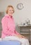 Woman sitting on exam table during checkup