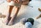 Woman sitting on the floor knitting cotton yarn