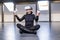 Woman sitting on floor in lotus position in wireless 360 view virtual reality headset. 3D device gadget for watching movies for