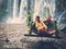 Woman sitting in flowered swing near waterfall, Phnom Koulen at Siem Reap, Cambodia