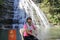 Woman sitting in front of the jade curtain waterfall on sanqingshan mountain, adobe rgb