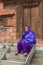 Woman sitting in front of a temple in Durban square at Kathmandu on Nepal