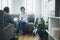 Woman sitting on a gray sofa during a meeting with a psychotherapist