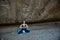Woman sitting on ground in mountains. Deep meditative state. Fresh air and Meditation. Contemplation or Yoga idea.