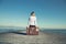 Woman sitting on her suitcase waiting for the sunset in a spectacular view