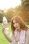 Woman Sitting and holding a bottle of water.