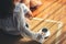 A woman sitting and holding a cup of hot coffee on the floor in the morning