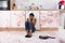 Woman Sitting On Kitchen Floor With Spilled Food